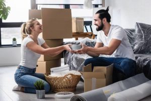 happy young couple packing up their home for a move